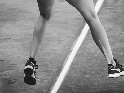 Dynamic shot of legs in motion on a track.